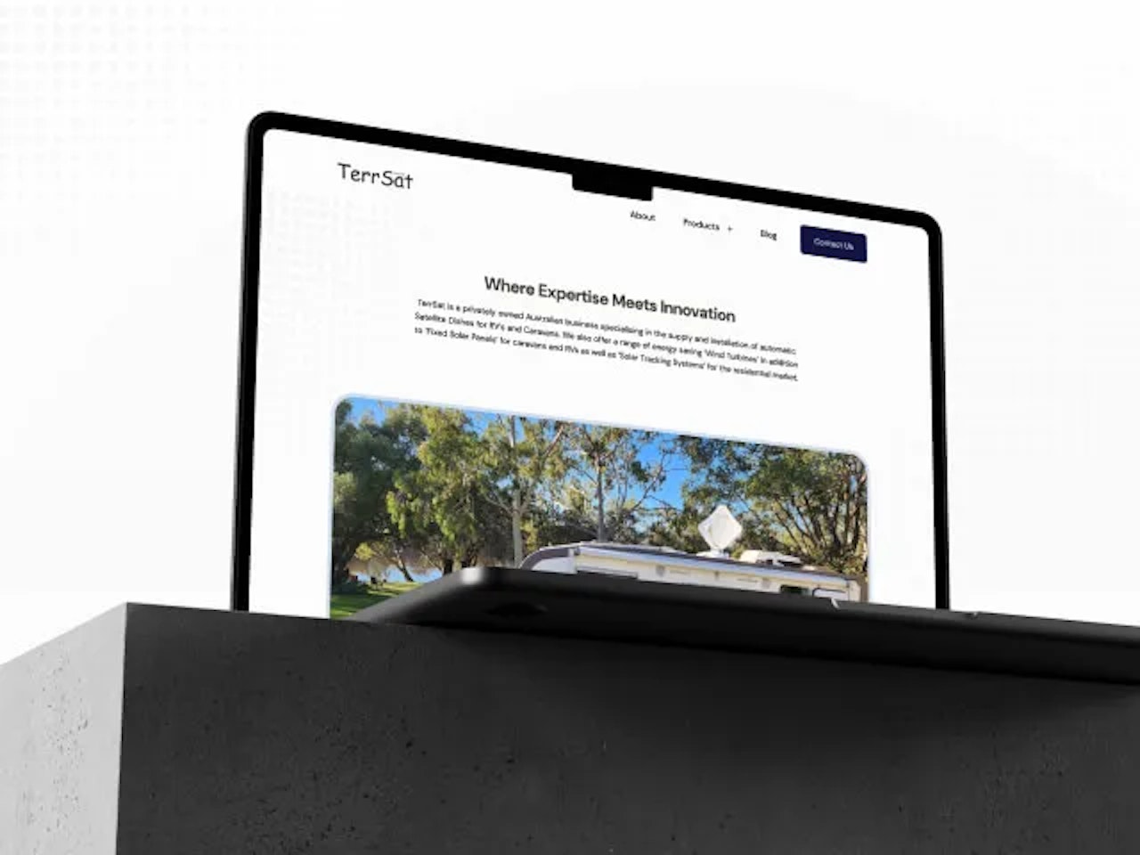 A photo of a laptop mockup with the TerrSat website featured inside of it.